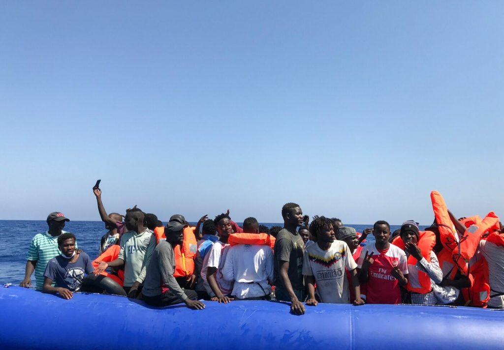 Taken from a "rhib", an inflatable dinghy, belonging to the 'Ocean Viking' rescue ship, operated by French NGOs SOS Mediterranee and Medecins sans Frontieres (MSF), some 81 migrants are rescued during an operation in the Mediterranean Sea on August 11, 2019. - The rescue operation comes as a dispute escalates over which countries will take in migrants rescued by different charity ships operating in the area, as mild Mediterranean weather increases the number of people trying to make their way to Europe from Africa. (Photo by Anne CHAON / AFP)