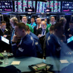 FILE PHOTO: Traders work on the floor at the New York Stock Exchange (NYSE) in New York, U.S., April 4, 2019. REUTERS/Brendan McDermid/File Photo