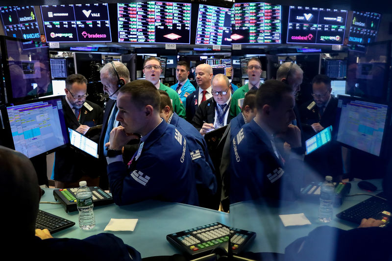 FILE PHOTO: Traders work on the floor at the New York Stock Exchange (NYSE) in New York, U.S., April 4, 2019. REUTERS/Brendan McDermid/File Photo